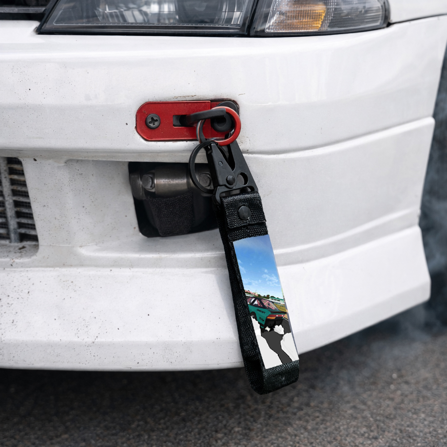 Downslide keychain fob mounted on a car's tow hook